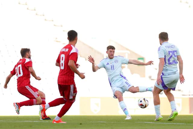 Ryan Christie of Scotland shoots under pressure from Ethan Britto of Gibraltar.
