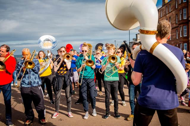 Molly MacLeod, 15, and Oscar Hilliam-Cook, 14, both centre in green, with other members of Edinburgh's Oi Musica who will march in the Queen's Platinum Jubilee Pageant