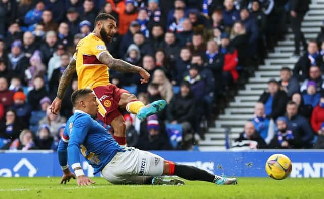 Kaiyne Woolery scores Motherwell's second goal in the 2-2 draw at Ibrox despite the efforts of Rangers captain James Tavernier. (Photo by Craig Williamson / SNS Group)