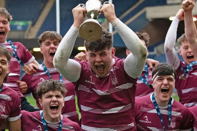 George Watson's captain Michael Connor with the Under-16 trophy after the win over Dollar Academy at Murrayfield. (Photo by Ross Parker / SNS Group)