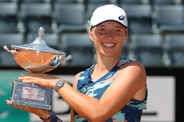 Iga Swiatek of Poland celebrates with the Internazionali BNL D'Italia Women's Singles trophy after their victory against Ons Jabeur of Tunisia during the Women's Single's Final on Day 8 of the Internazionali BNL D'Italia at Foro Italico on May 15, 2022 in Rome, Italy