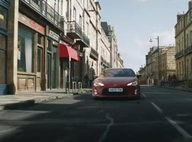 The trailer shows a car racing down what appears to be a composite incorporating Melville Street in the West End of the city before crashing through a whisky shop (Photo: Universal Pictures).