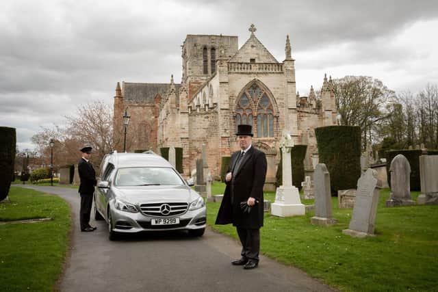 A Mercedes silver palladium hearse outside St Mary's Church in Haddington.