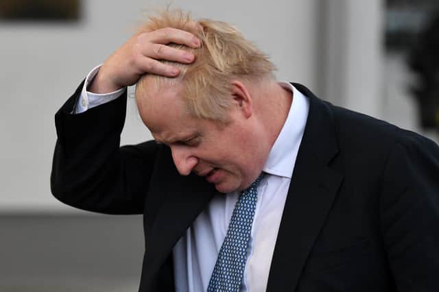 Prime Minister Boris Johnson prepares to speak with members of the media during a visit to Warszawska Brygada Pancerna military base on February 10. Pucture: Daniel Leal/Getty Images