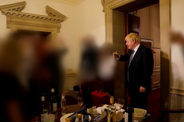 Boris Johnson is pictured with a drink during the same event for the departure of a special advisor at No 10 Downing Street.