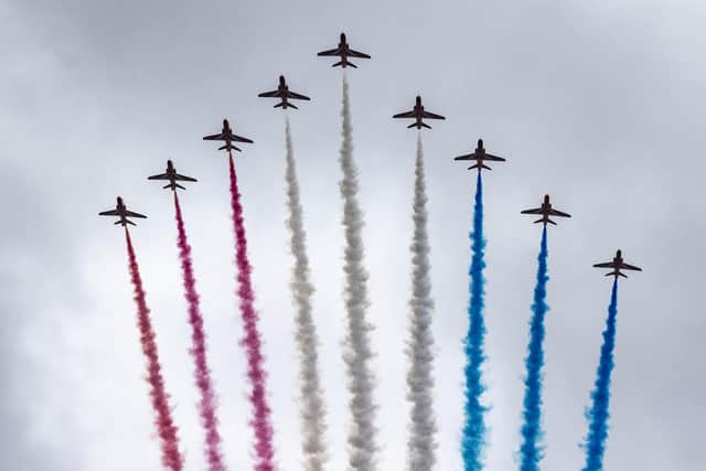 The Red Arrows take part in the fly past as they fly over The Mall after the coronation of King Charles III and Queen Camilla in London.