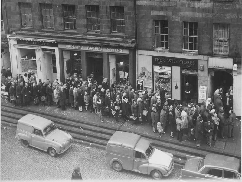 Queues in Edinburgh's Lawnmarket to collect Hogmanay refreshments, 1966.