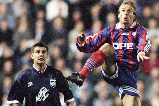 Bayern Munich's Jurgen Klinsmann wins the ball ahead of Raith Rovers' Shaun Dennis in the first leg of the UEFA CUp third round tie at Easter Road.