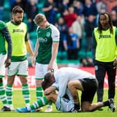 Hibs assistant manager Jamie McAllister and several players attempt to console the recently-bereaved Marijan Cabraja at the conclusion of their league draw with Rangers. Photo by Ross Parker / SNS Group