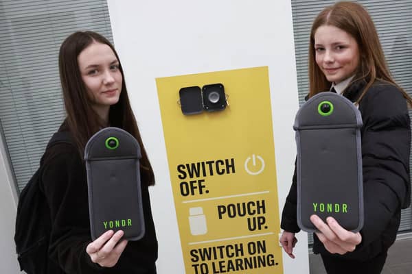 Portobello High School was the first in Scotland to introduce a zero-phone policy for pupils. Pupils  place their devices into magnet-locked Yondr pouches for the duration of the school day. Pictured are S3 pupils Julia and Carly (Picture: Lisa Ferguson)