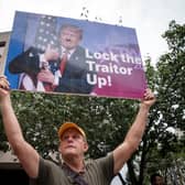 A person holds up a sign with a photograph of former President Donald Trump outside of the E. Barrett Prettyman United States Courthouse in Washington, DC. President Donald Trump arrived at the Courthouse to be arraigned on Thursday afternoon after being indicted on four felony counts for his alleged efforts to overturn the 2020 election.