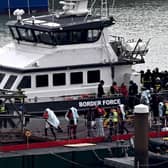 Migrants are escorted ashore from the UK Border Force vessel 'BF Ranger' in Dover, southeast England, on Monday, after having been picked up at sea while attempting to cross the English Channel. Picture: AFP via Getty Images