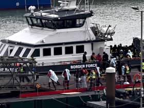 Migrants are escorted ashore from the UK Border Force vessel 'BF Ranger' in Dover, southeast England, on Monday, after having been picked up at sea while attempting to cross the English Channel. Picture: AFP via Getty Images