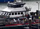 Migrants are escorted ashore from the UK Border Force vessel 'BF Ranger' in Dover, southeast England, on Monday, after having been picked up at sea while attempting to cross the English Channel. Picture: AFP via Getty Images