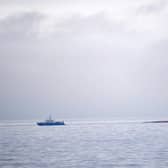 The capsized Danish cargo ship Karin Hoej (R) is pictured on the Baltic Sea, between the Swedish city of Ystad and the Danish island of Bornholm, after colliding with the British cargo ship Scot Carrier early Monday morning.