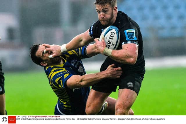 Glasgow's Kyle Steyn hands off Zebre's Enrico Lucchin's during the Warriors' win in Parma. Photo by Luca Sighinolfi/INPHO/Shutterstock