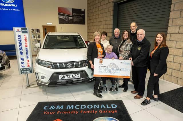 Susan Crighton and Donna Deans from Charlie House with Alan Pirie and members of the Rotary Clubs, handing over this year's prize to Jenny Kemp. (Pic: Michal Wachucik)