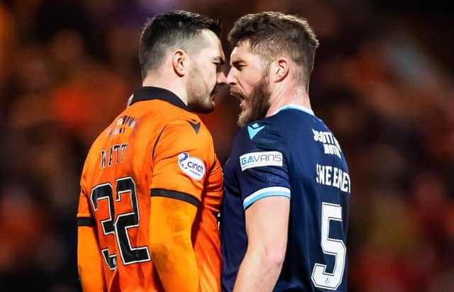 Dundee United striker Tony Watt and Dundee defender Ryan Sweeney square up during the derby clash at Dens Park.  (Photo by Roddy Scott / SNS Group)