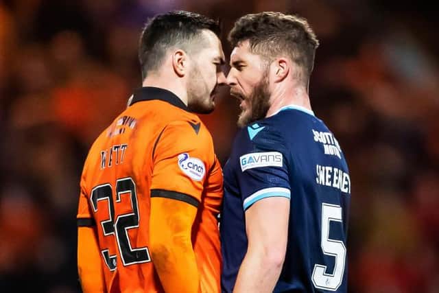 Dundee United striker Tony Watt and Dundee defender Ryan Sweeney square up during the derby clash at Dens Park. (Photo by Roddy Scott / SNS Group)