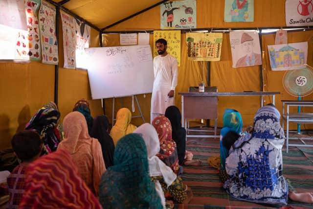 Yasir teaches a class at a temporary learning centre set up by Save The Children in Sindh, Pakistan for a community after unprecedented monsoon floods destroyed the local government school building last summer.