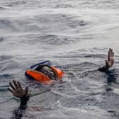 A woman tries to board a rescue boat in the Mediterranean Sea after her vessel sank, with the deaths of five people, including a new-born child (Picture: Alessio Paduano/AFP via Getty Images)