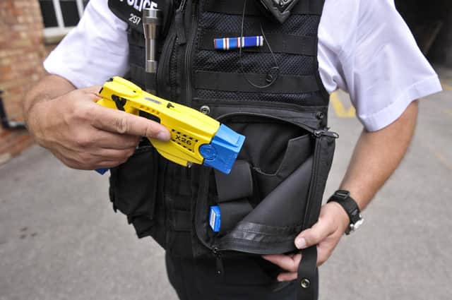 A police officer holstering his Taser X26 during a training exercise. Picture: Ben Birchall/PA Wire