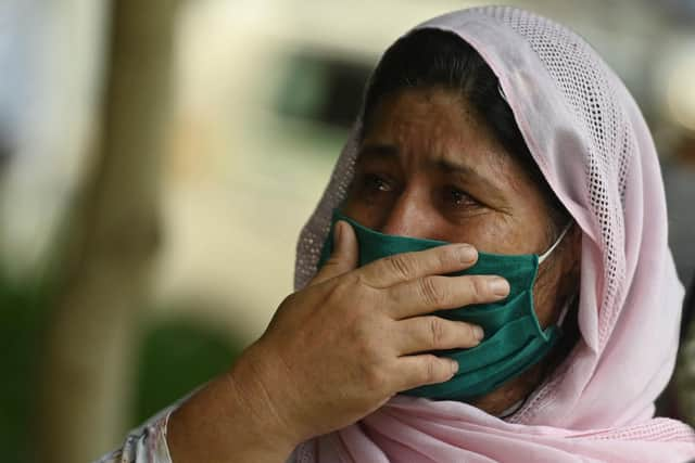 An Afghan woman outside the embassy of the United States of America in New Delhi (Photo by Money Sharma / AFP) (Photo by MONEY SHARMA/AFP via Getty Images)