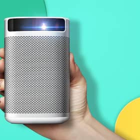 The XGIMI MoGo Pro 1080p portable projector is a compact, neat, curved-edge unit of white and silver. Image XGIMI
