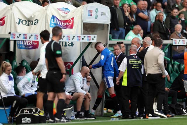 John Lundstram of Rangers leaves the field after being shown a second yellow card.