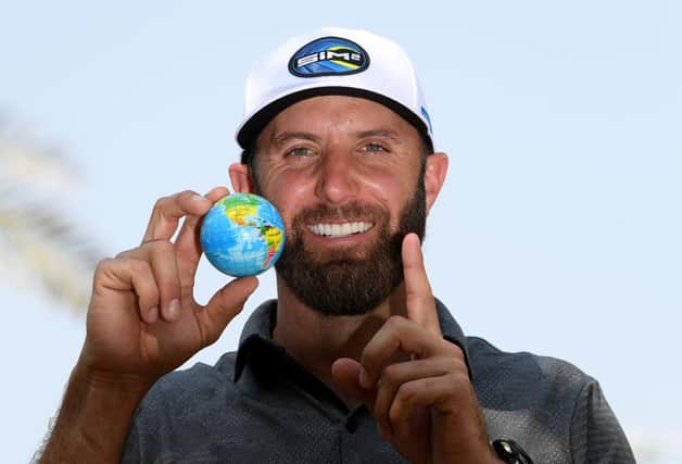 World No 1 Dustin Johnson poses with a globe ahead of the Saudi International powered by SoftBank Investment Advisers at Royal Greens Golf and Country Club in King Abdullah Economic City. Picture: Ross Kinnaird/Getty Images.