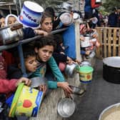 Palestinians children wait to collect food at a donation point in a refugee camp in Rafah, in the southern Gaza Strip, as fighting continues between Israel and militant group Hamas. Picture: Mahmud Hams/AFP via Getty Images