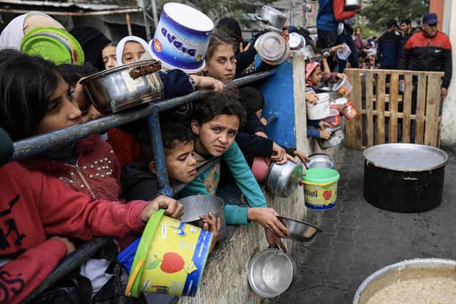 Palestinians children wait to collect food at a donation point in a refugee camp in Rafah, in the southern Gaza Strip, as fighting continues between Israel and militant group Hamas. Picture: Mahmud Hams/AFP via Getty Images
