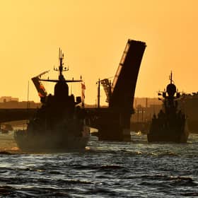 Russian warships sail on the Neva river through raised drawbridges during a rehearsal for the Naval parade in Saint Petersburg. Picture: Olga Maltseva/AFP via Getty Images