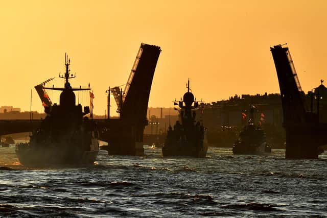 Russian warships sail on the Neva river through raised drawbridges during a rehearsal for the Naval parade in Saint Petersburg. Picture: Olga Maltseva/AFP via Getty Images