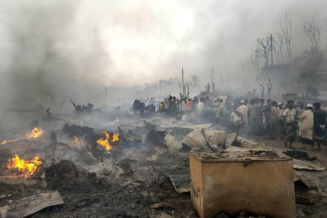 Rohingya refugees try to salvage their belongings after a major fire in their Balukhali camp at Ukhiya in Cox's Bazar district, Bangladesh.