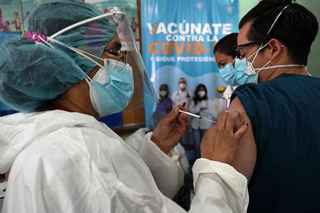 A nurse inoculates a man with an AstraZeneca vaccine against COVID-19 at the Alonso Suazo healthcare center in Tegucigalpa, on March 15, 2021 Photo by ORLANDO SIERRA/AFP via Getty Images