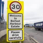A haulage lorry driving passed a sign at Belfast Port, as The Northern Ireland Protocol has created a "feast or famine" economy in the region with some businesses struggling while others thrive, a parliamentary report has found.