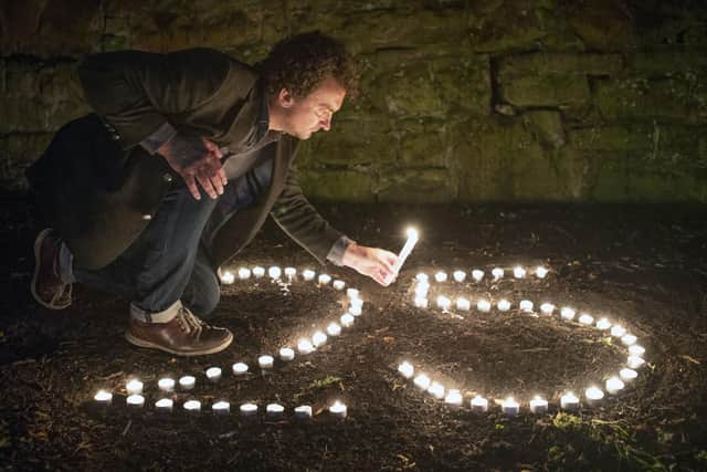 BAFTA award-winning film director Samir Mehanovic, who came to the UK as an immigrant from the Bosnian war in 1995 and now lives in Edinburgh, lights candles to commemorate the 25th anniversary of the Srebrenica genocide. Jane Barlow/PA Wire