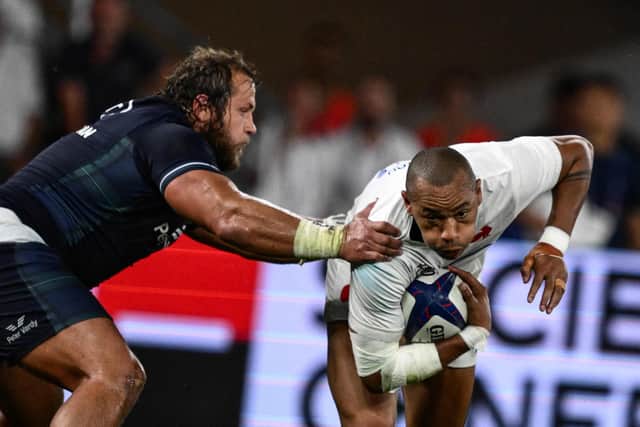 France's inside centre Gael Fickou is tackled by Scotland's loosehead prop Pierre Schoeman.