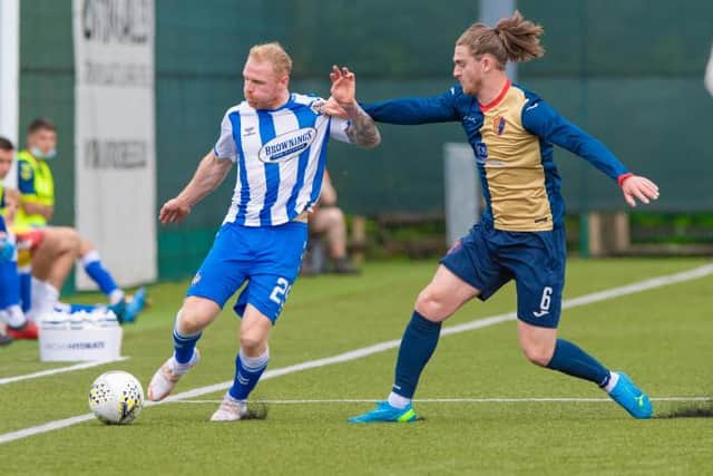Kilmarnock winger Chris Burke is challenged by East Kilbride midfielder Blair Malcolm during the Premier Sports Cup match at K-Park. (Photo by Mark Scates / SNS Group)