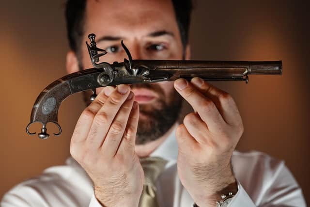 Colin Fraser, Specialist in Arms and Armour at Lyon & Turnbull, with the specially made pistol. (Picture credit: Stewart Attwood)