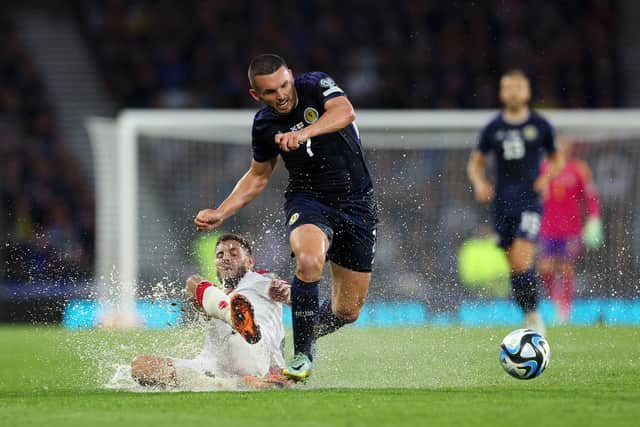 John McGinn of Scotland is tackled by Lasha Dvali of Georgia during the match at Hampden.