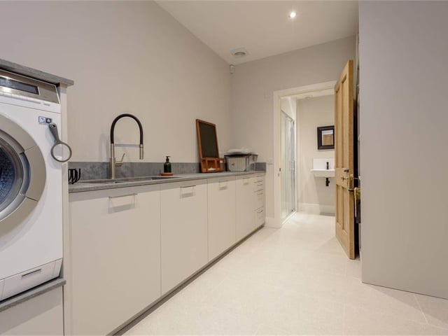 Utility room looking through to shower room.