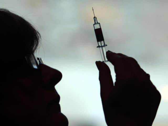 A nurse preparing to give a patient a vaccine Picture: PA