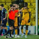 Referee Grant Irvine checks VAR which shows an offside before the foul by Hibs' Paul Hnalon on Livingston's Mo Sangare.