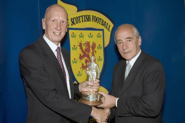 Retiring referee John Rowbotham (left) recieves an award at the conference in St Andrews from Bob Valentine, chairman of the SFA Referee Supervisors' Sub-Commitee, in 2005.