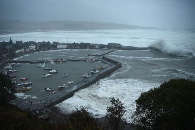 Waves crash over Stonehaven harbour on the east coast of Scotland as Storm Babet hit in October 2023 (Pic: Andy Buchanan/AFP via Getty Images)