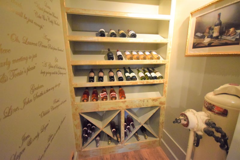 The wine room is accessed by a unique glass door from the snug.