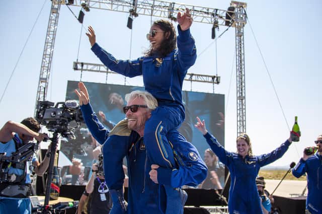 Virgin Galactic founder Richard Branson carries crew member Sirisha Bandla on his shoulders while celebrating their flight to space