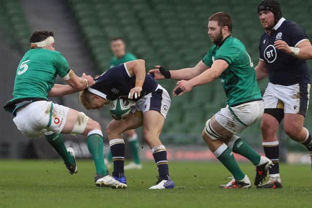 Scotland's fly-half Jaco Van Der Walt is tackled by Ireland's lock James Ryan.